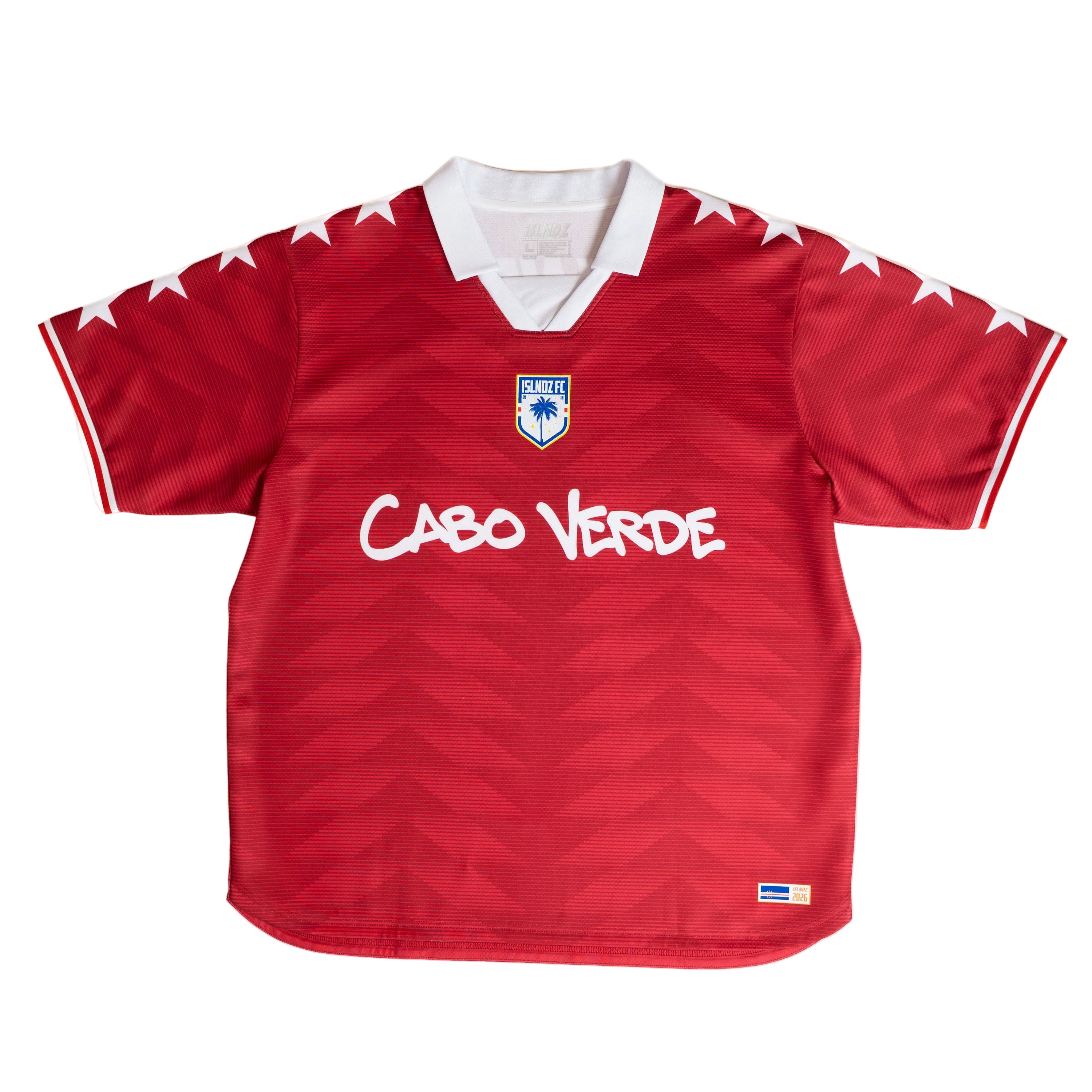 A red short-sleeve soccer jersey with a white collar, white star details on the shoulders, and 'Cabo Verde' written in white across the chest. The jersey features a subtle wavy pattern and a small national crest on the center chest.